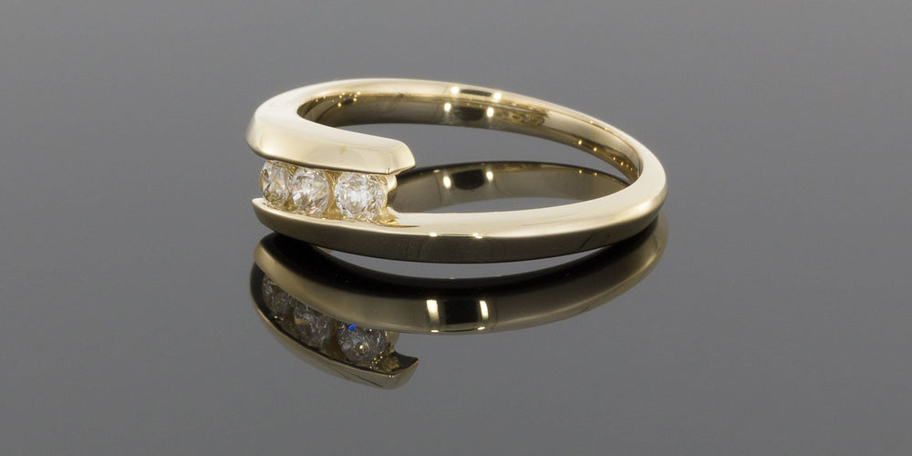 .25CTW Three Round Diamonds Bypass Ring